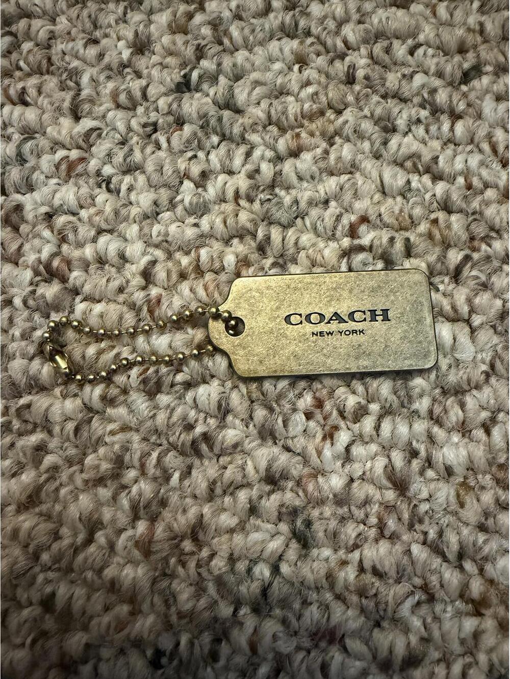Coach brushed brass metal 1.5" hangtag